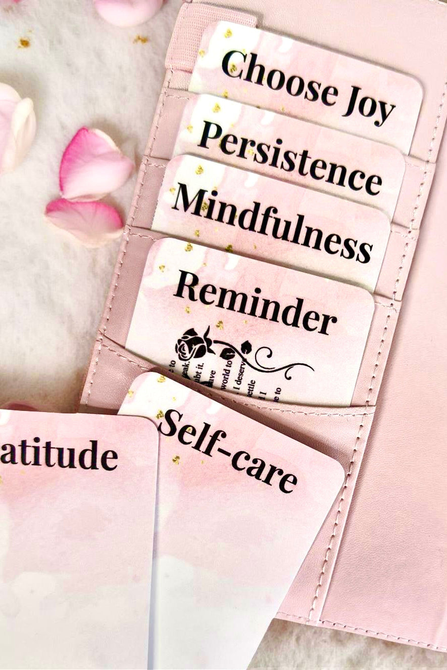 Pink planner with motivational stickers on a soft pink background