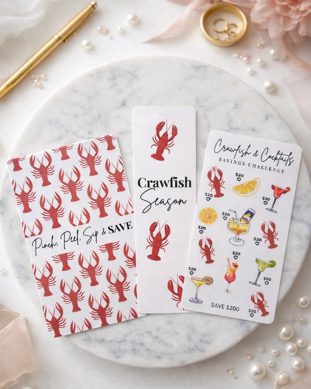 Three crawfish-themed cards on a marble surface with decorative elements.