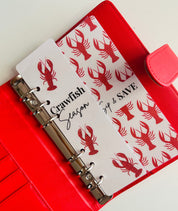 Red binder with lobster design on a white background