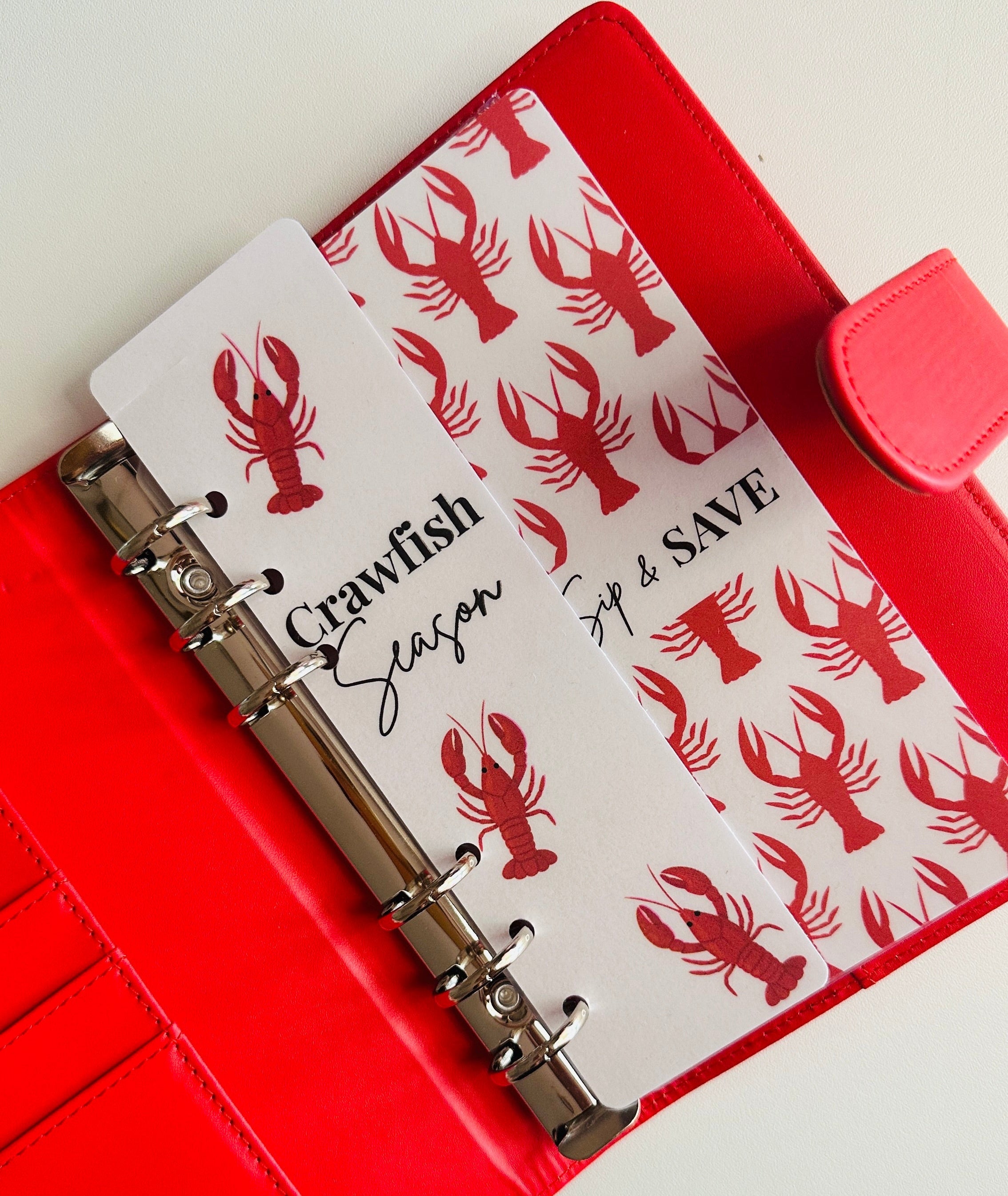 Red binder with lobster design on a white background