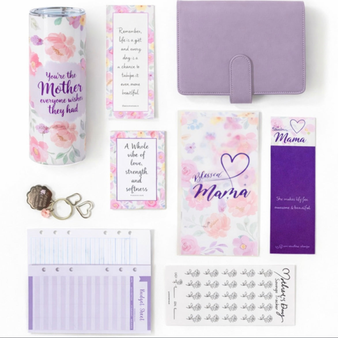 Collection of stationery items with floral and motivational designs on a white background
