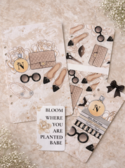 Sticker sheets with fashion-themed designs on a textured surface.