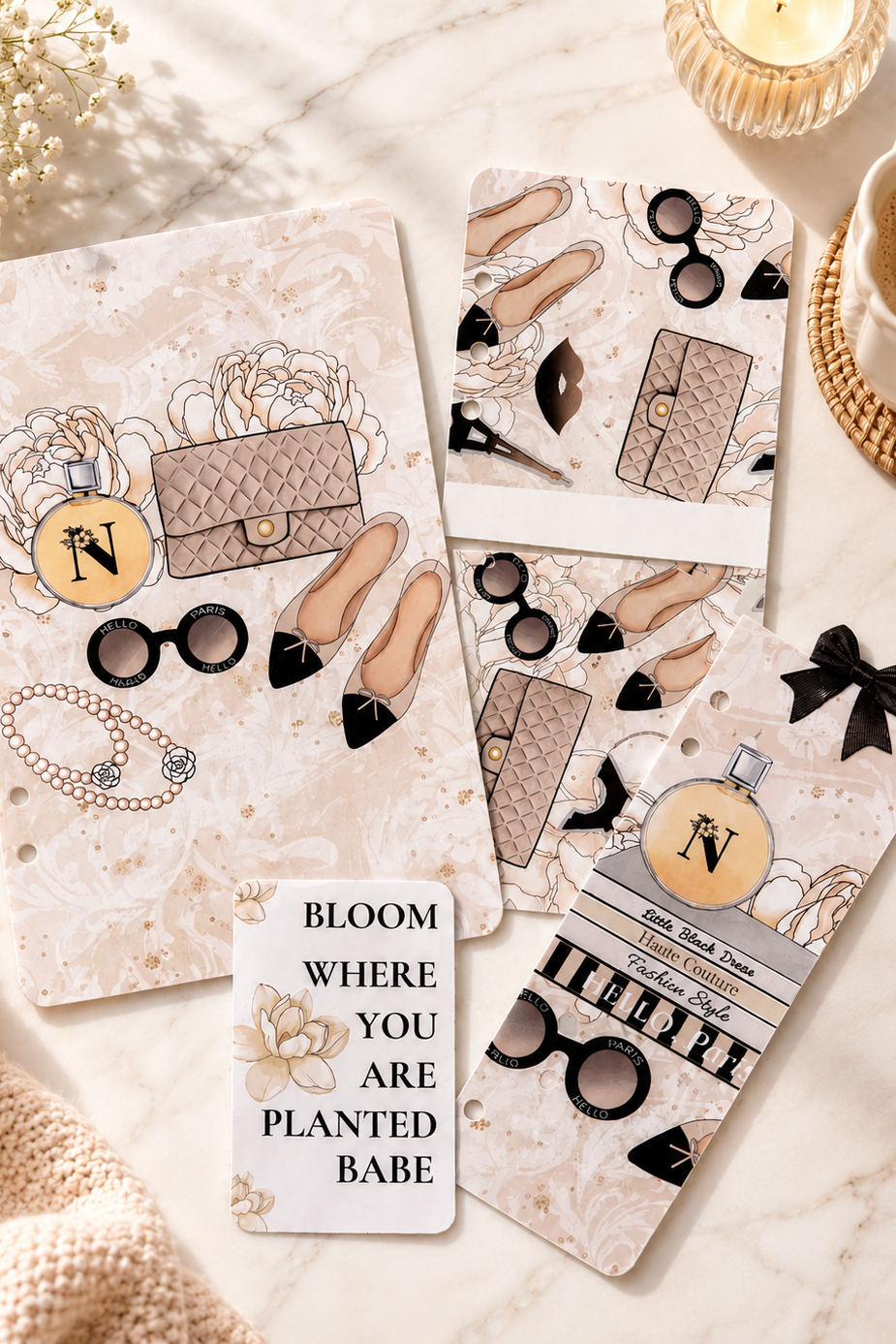 Decorative cards with fashion-themed illustrations on a marble surface.