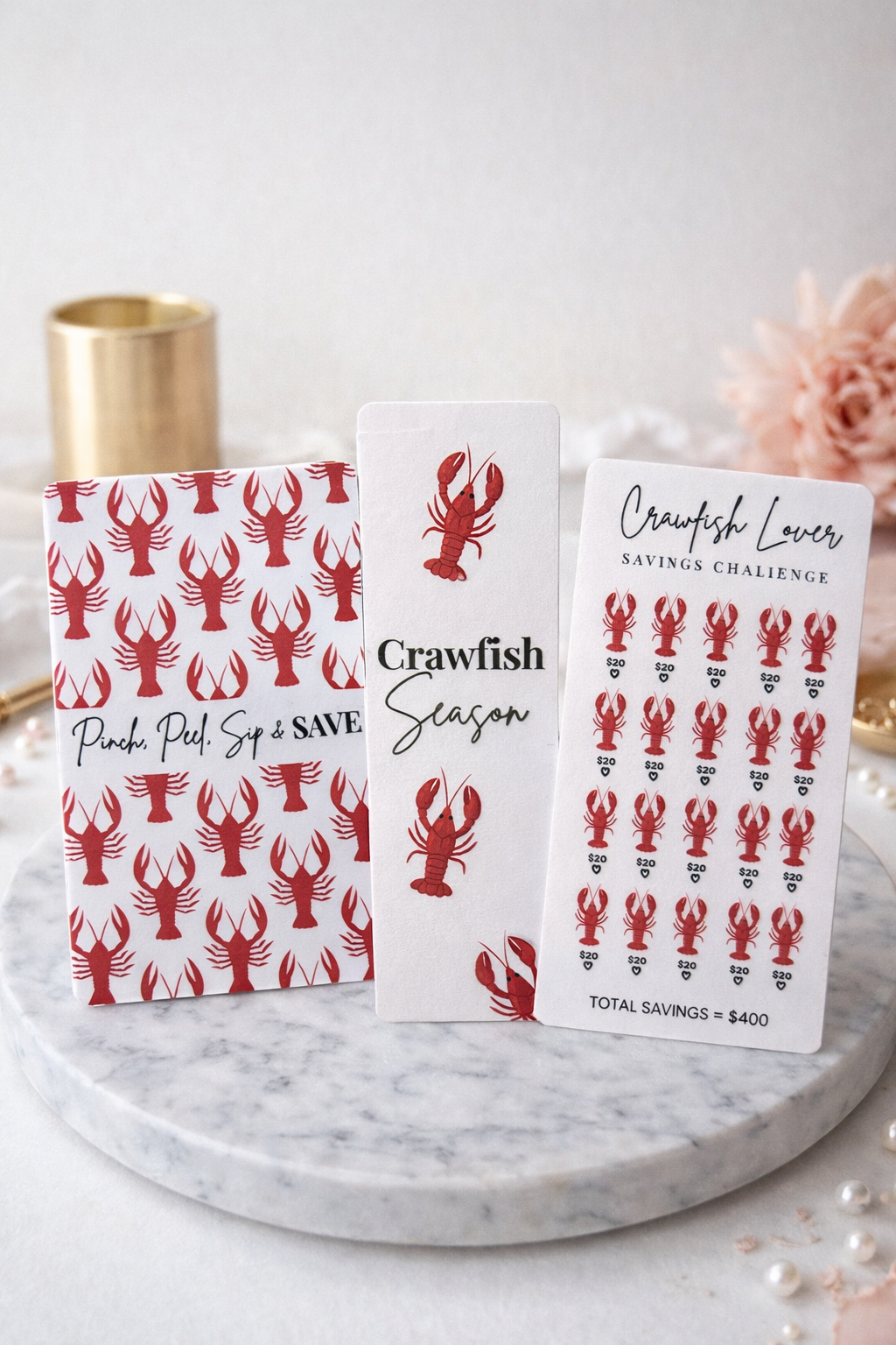 Three cards with crawfish patterns and text on a marble surface.