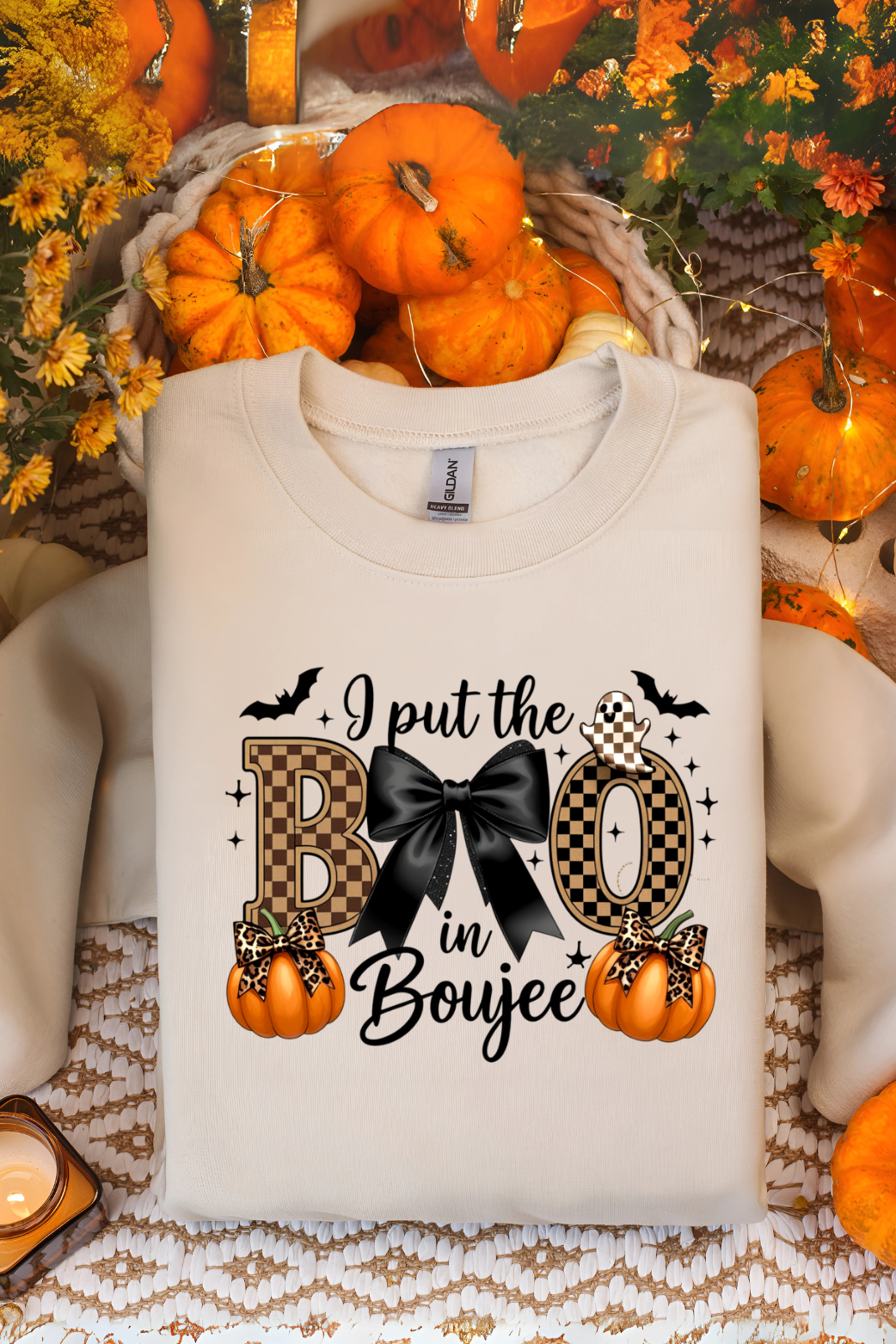 White sweatshirt with Halloween-themed design surrounded by pumpkins and fall decorations