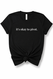Black t-shirt with 'it's okay to pivot.' text on a white background